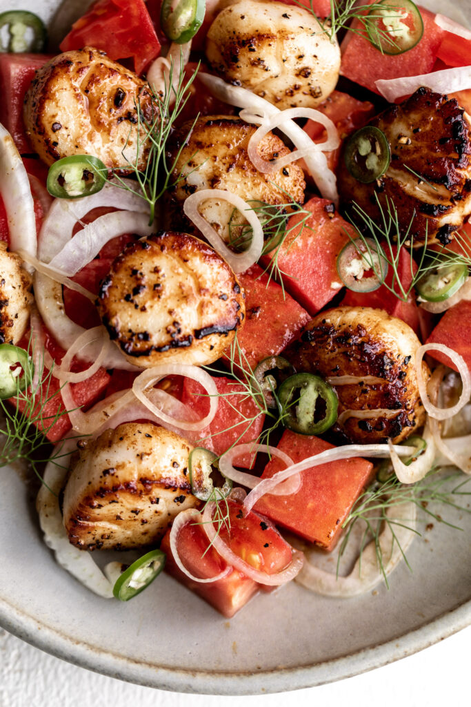 scallops are seared to golden-brown and are served in a nutty brown butter sauce that contrasts with the fresh, sweet taste of watermelon and spicy  Serrano pepper.