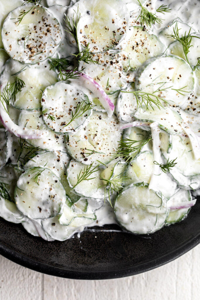 In this creamy cucumber salad recipe, sliced cucumber is tossed in creamy dressing made from sour cream and vinegar mixture with fresh dill.