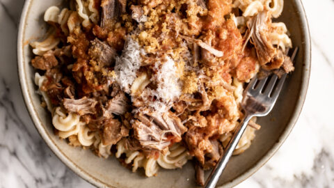 Braised pork roast made in a simple tomato-based sauce finished with cream and topped with buttered breadcrumbs.