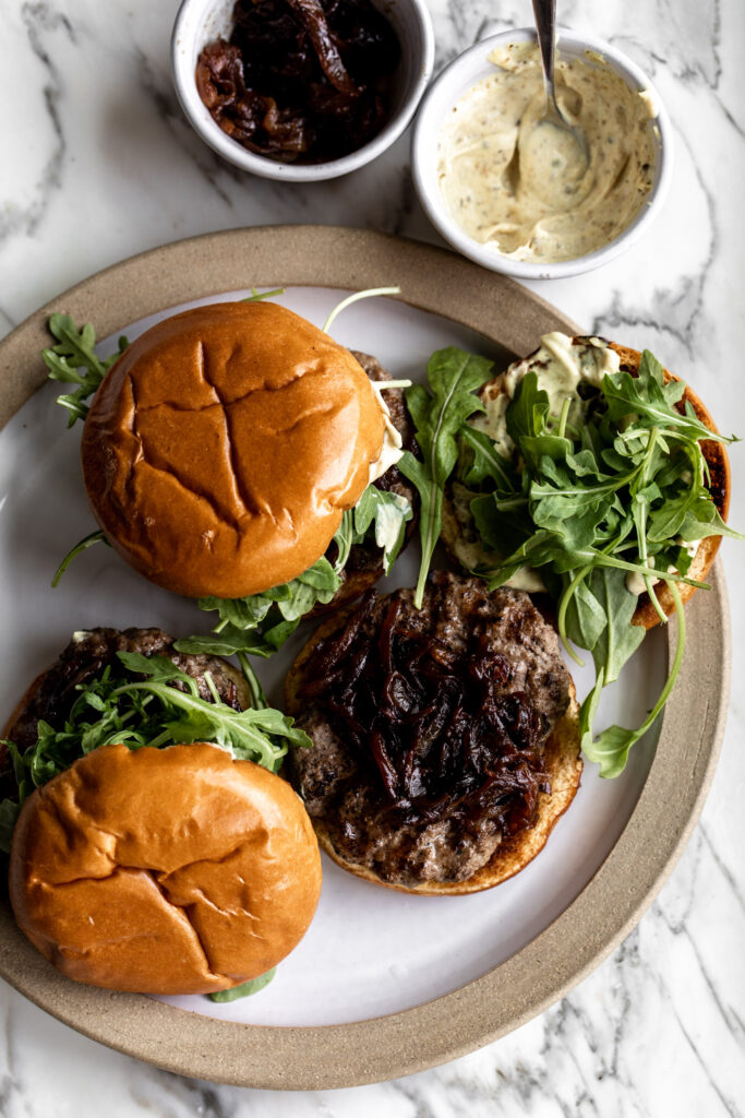 open face lamb burgers made on with caramelized onions, arugula and curry mayo with ingredients on the side