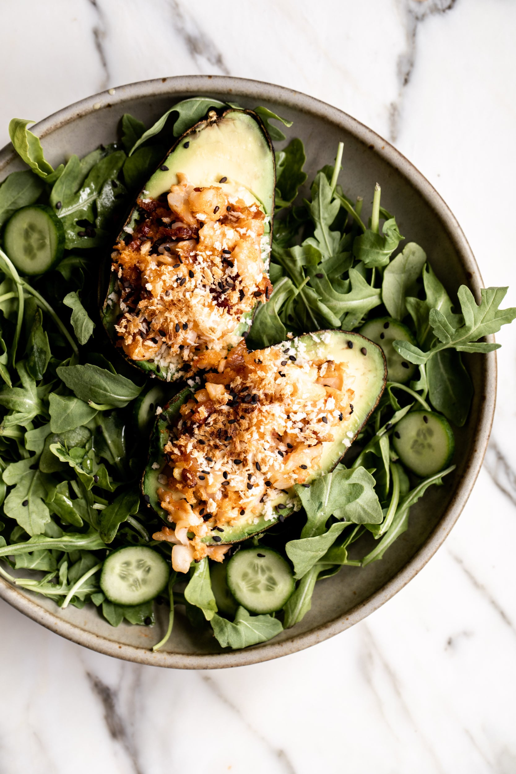 Spicy Shrimp-Salad Stuffed Baked Avocados over arugula salad with cucumber.
