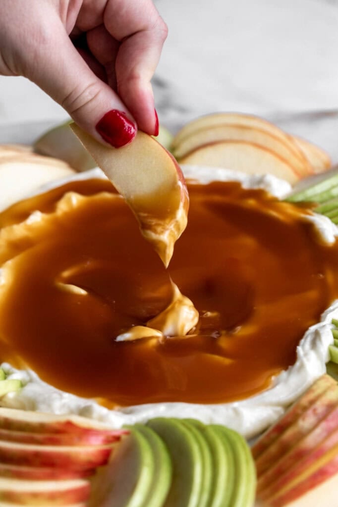homemade caramel apple dip with slices of apples for serving.