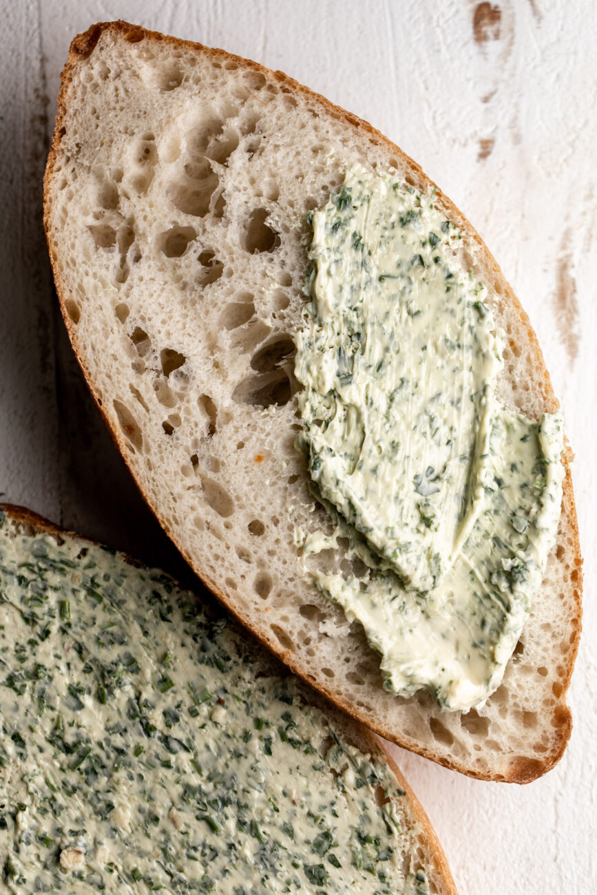 garlic butter spread over loaf of bread.