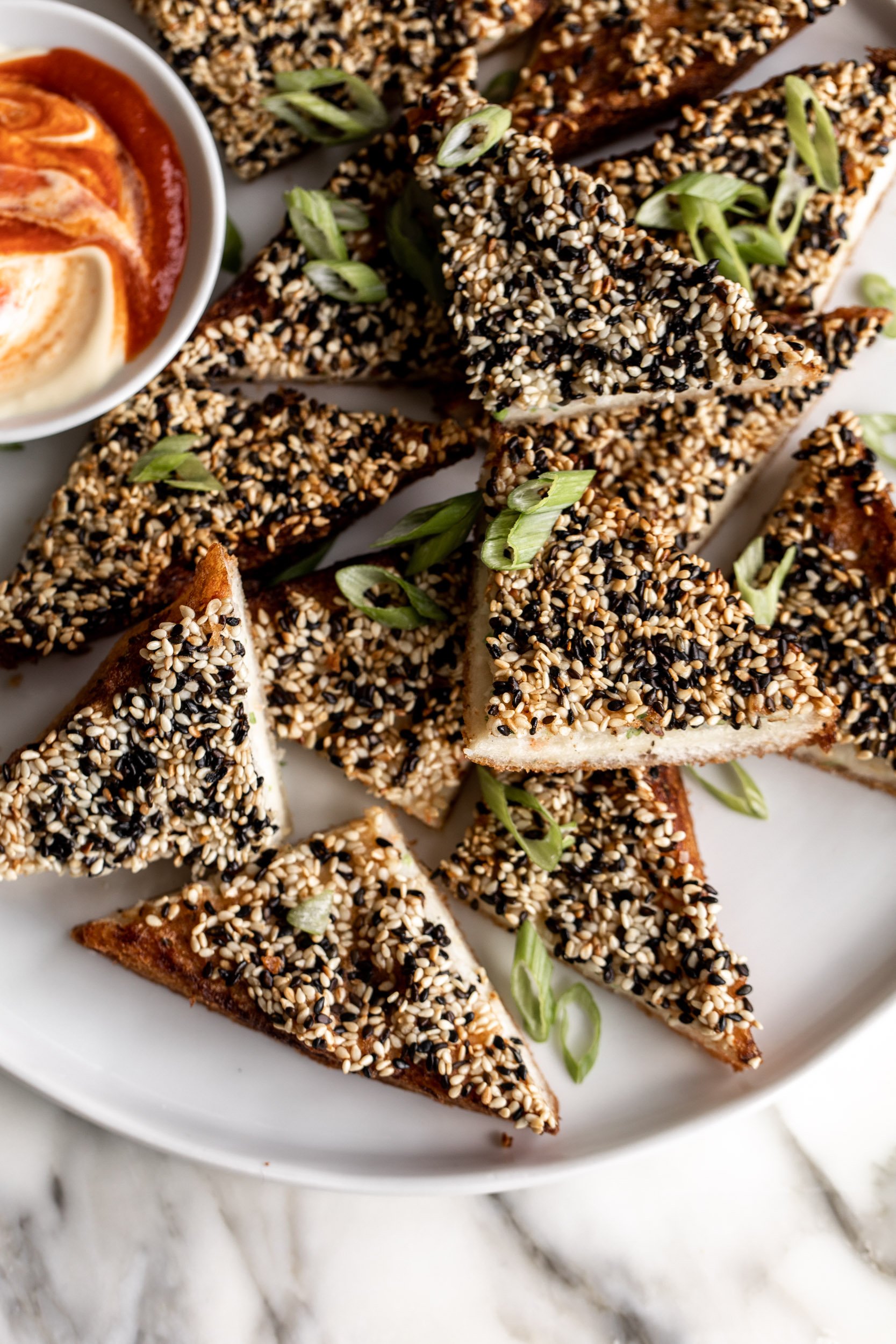 shrimp toasts with black and white sesame seeds.