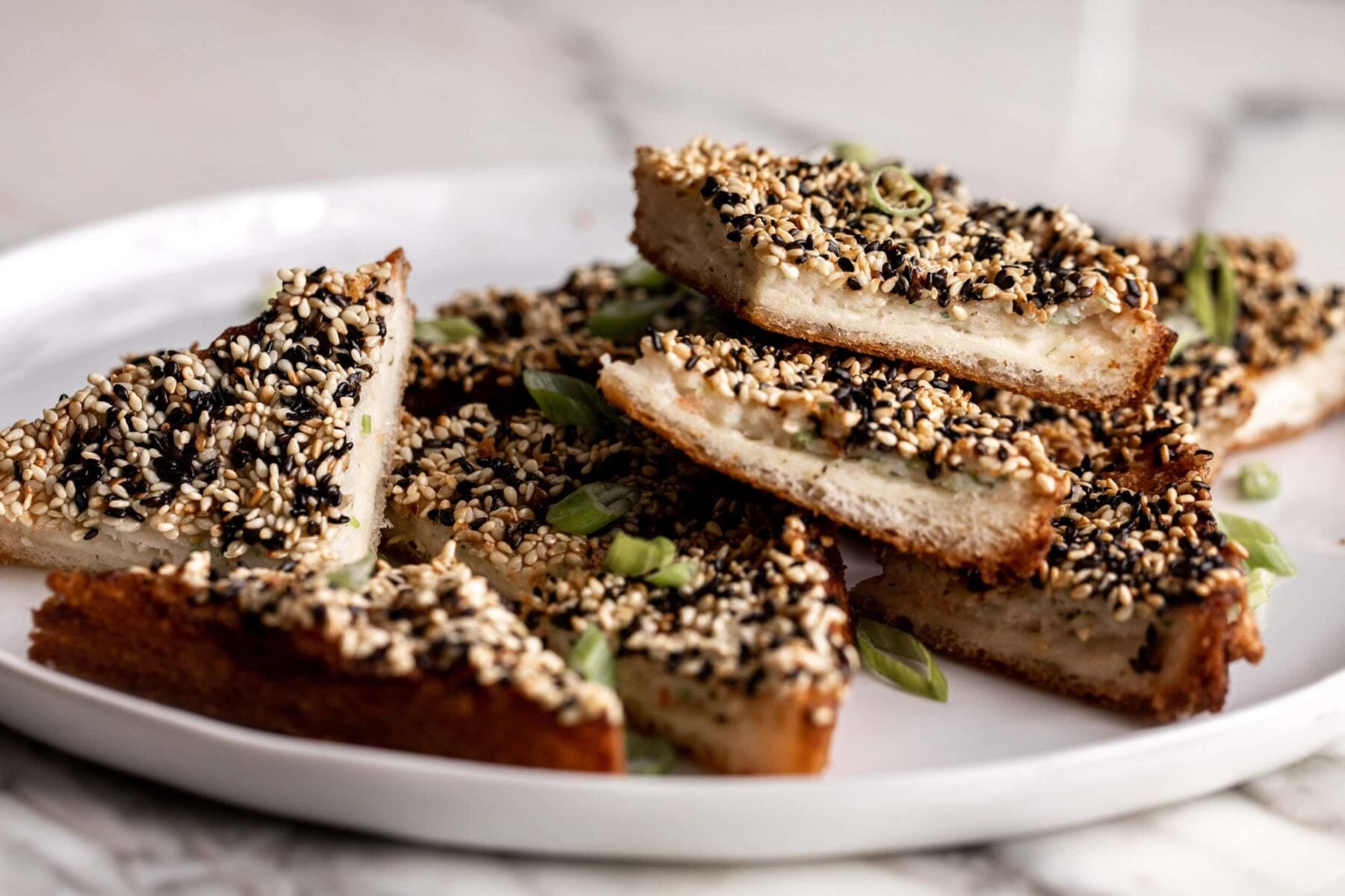 fried Chinese takeout classic shrimp toasts on bread with sesame seeds.