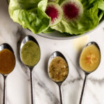 4 types of basic vinaigrette on spoons with butter lettuce salad