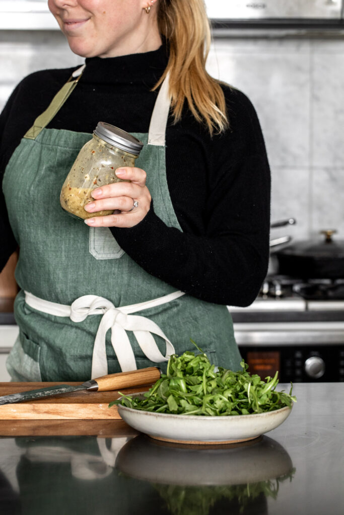 shake vinaigrette in a mason jar to emulsify with arugula salad