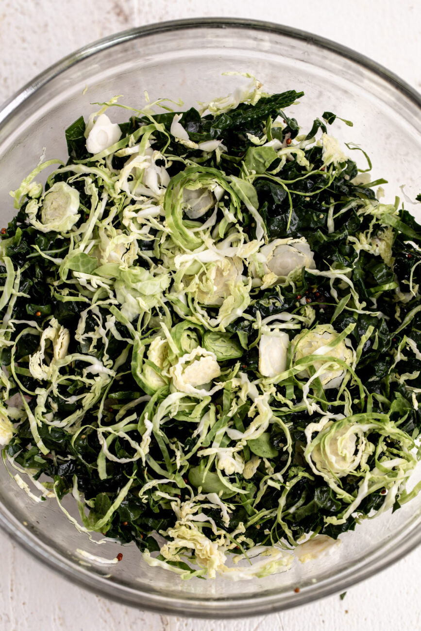 shaved brussels sprouts salad with kale in dressing.
