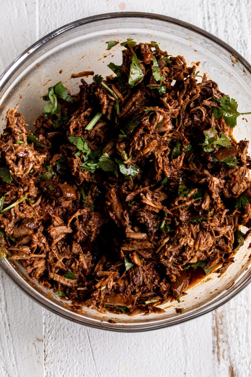 braised birria meat chopped and mixed with braising liquid.