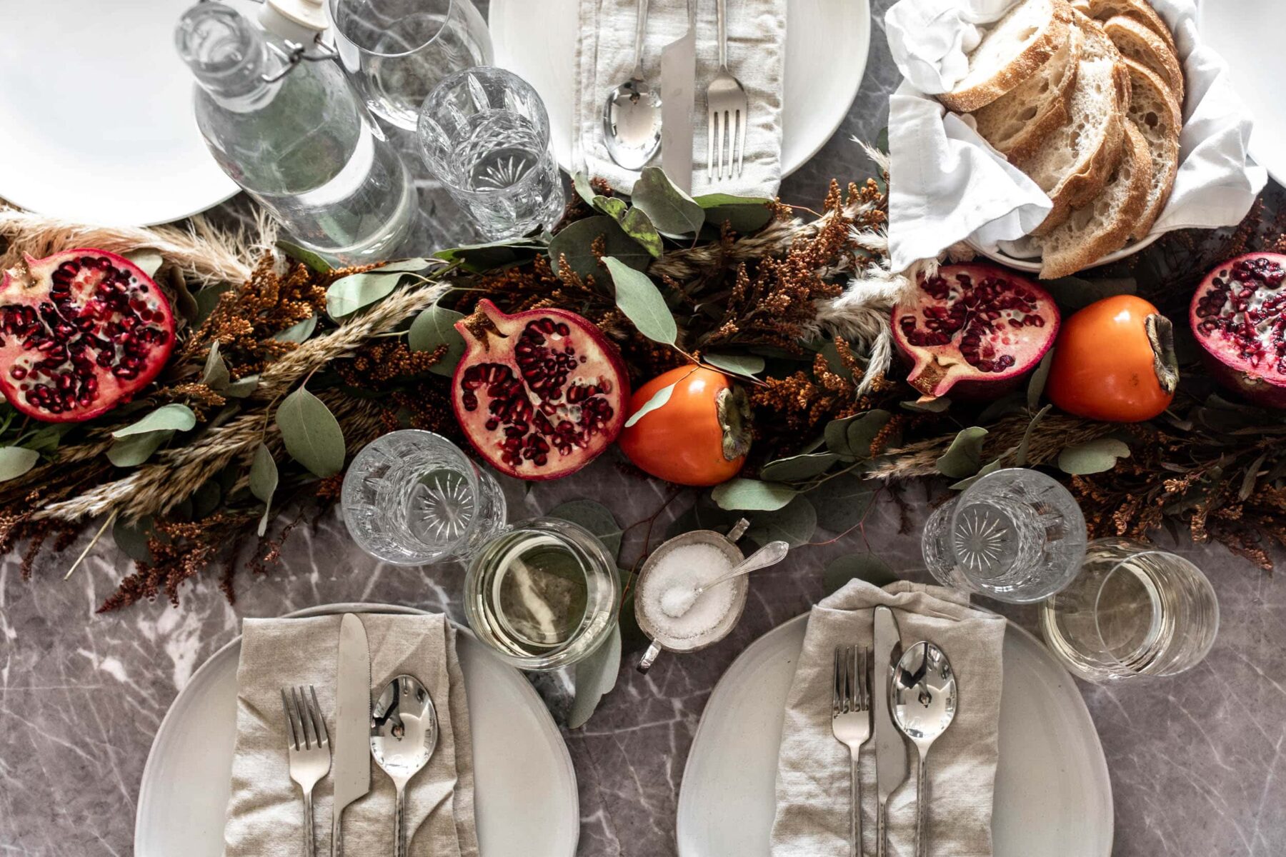 thanksgiving tablescape decorated with persimmon and pomegranate.