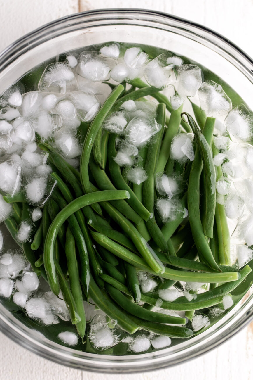 blanched green beans in ice bath.