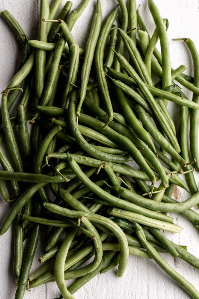 green beans on white wood board