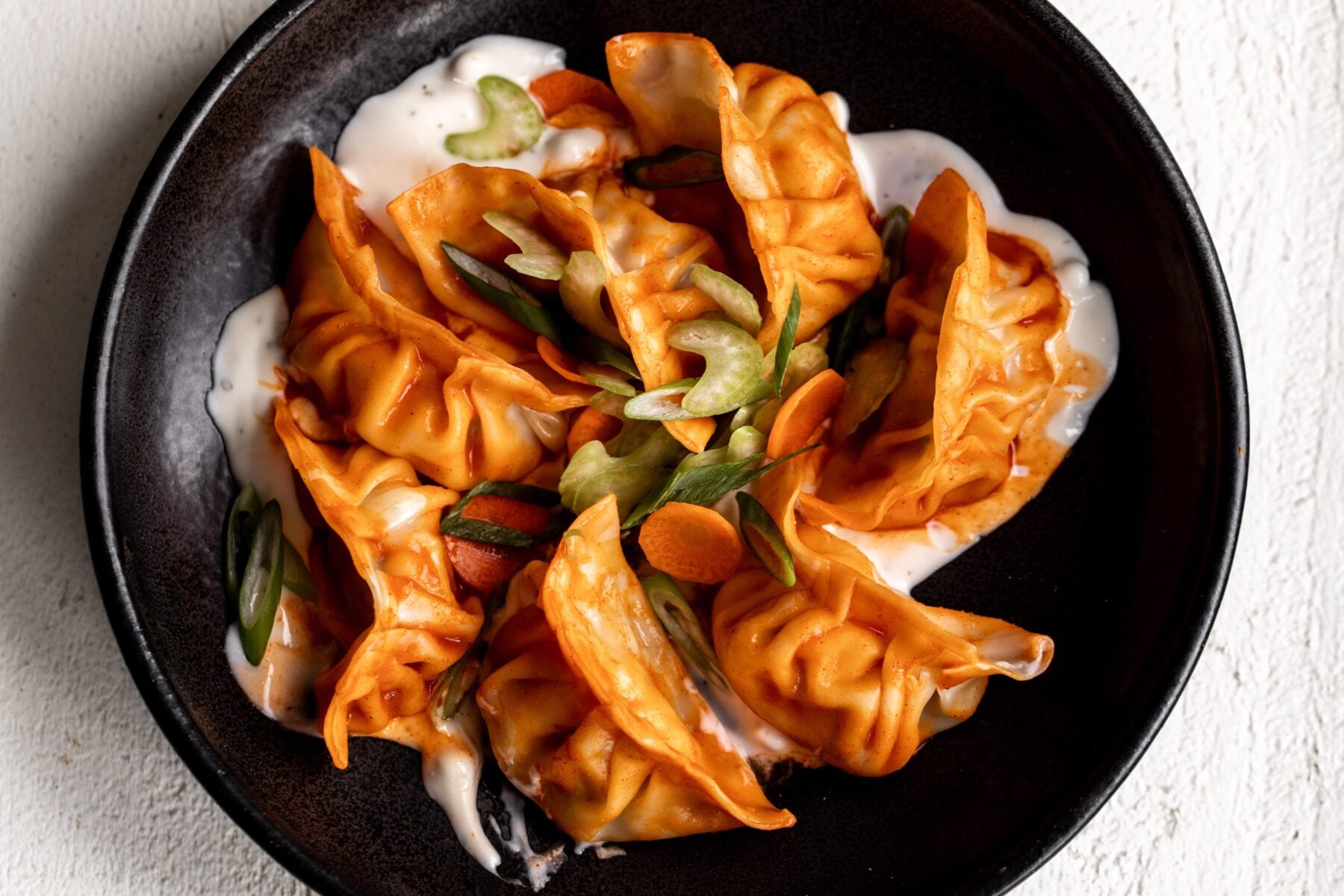 Buffalo Chicken Dumplings Recipe with blue cheese and celery.