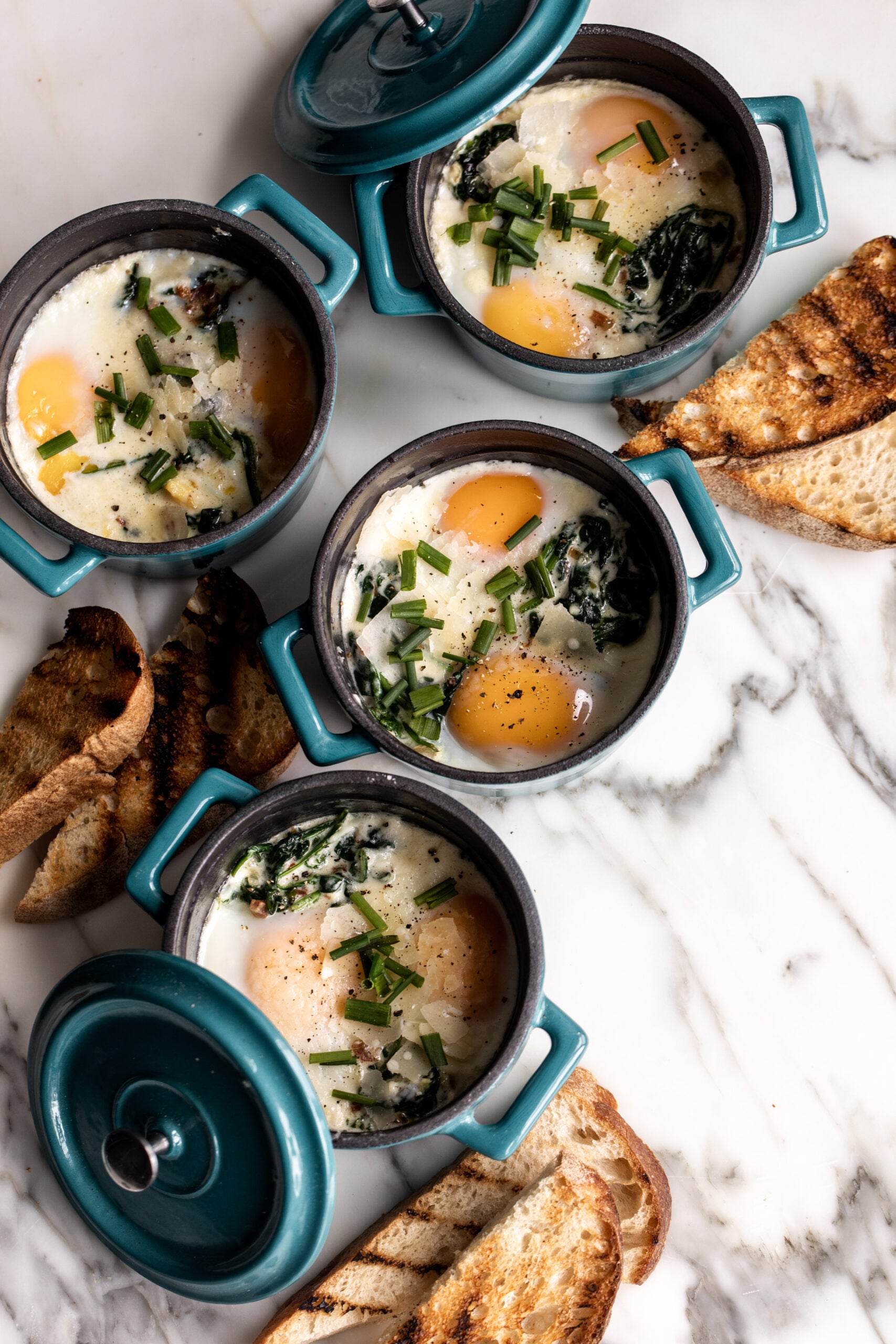 Eggs en Cocotte: Baked Eggs in Ramekins with Spinach & Pancetta with grilled bread.