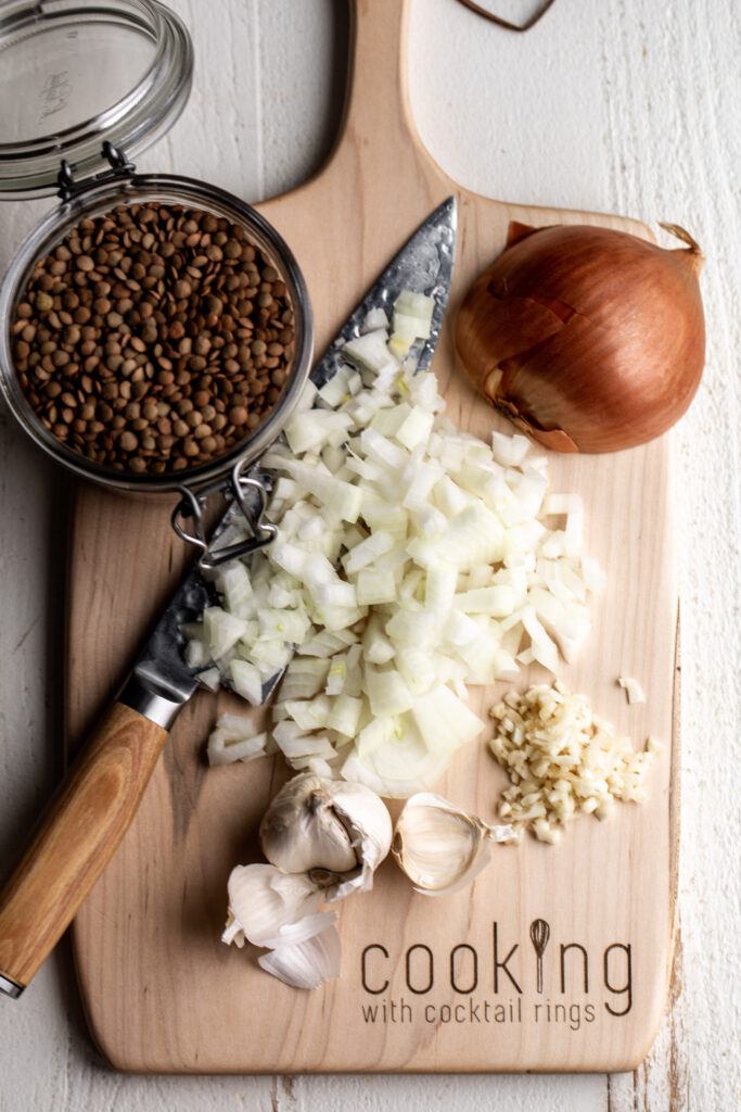 diced onion on cutting board with lentils