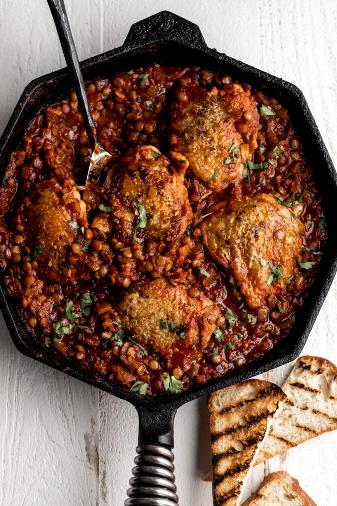 One-Pan seared Chicken Thighs with Harissa Lentils and tomatoes 