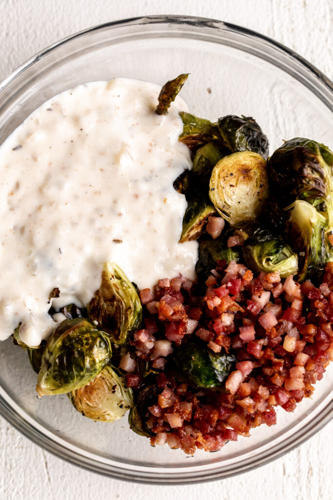 Bechamel and brussels sprouts with pancetta in bowl