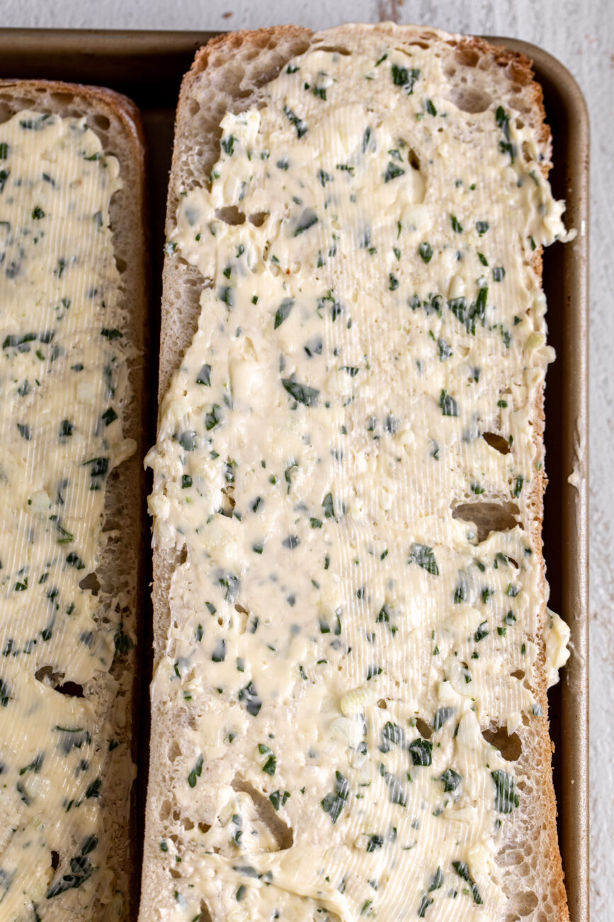 ciabatta bread spread with garlic butter.