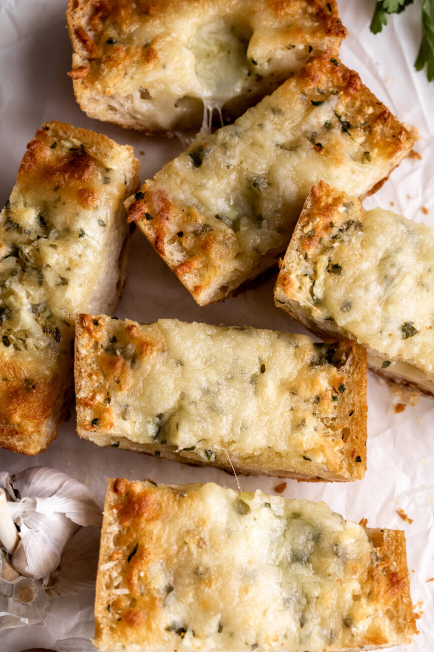 baked cheesy garlic bread cut into pieces.