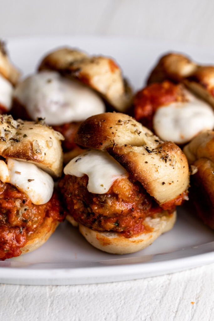 Garlic Knot Meatball Sliders with tomato sauce and melted mozzarella cheese recipe