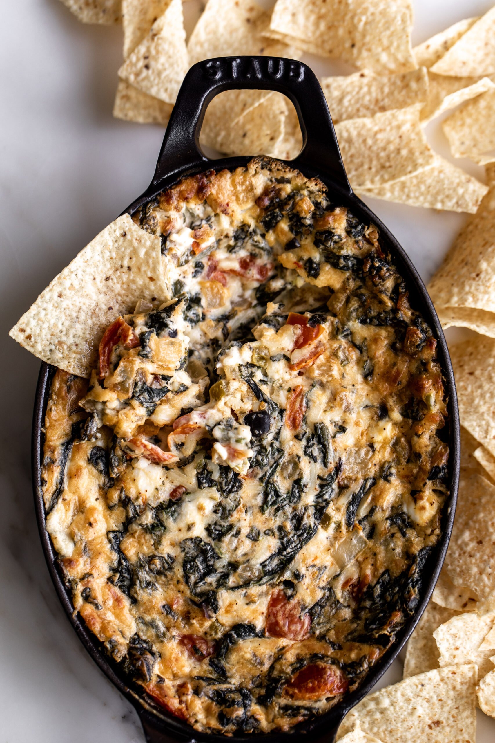 hot spinach dip with tortilla chips for dipping.