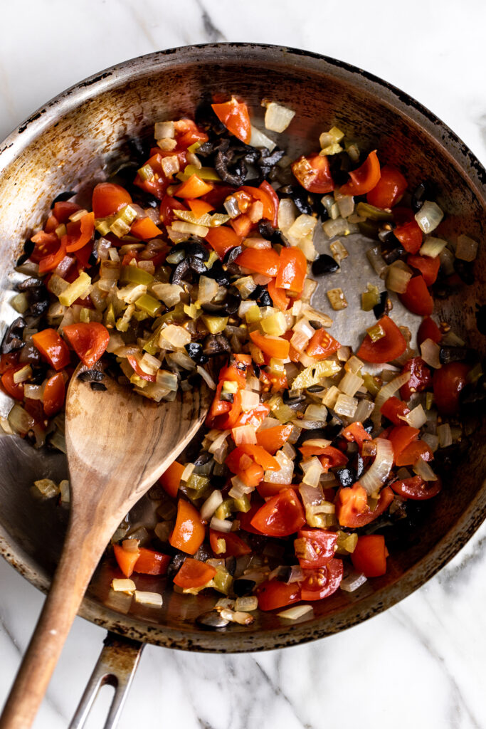 tomatoes, chilies and olives in sauté pan