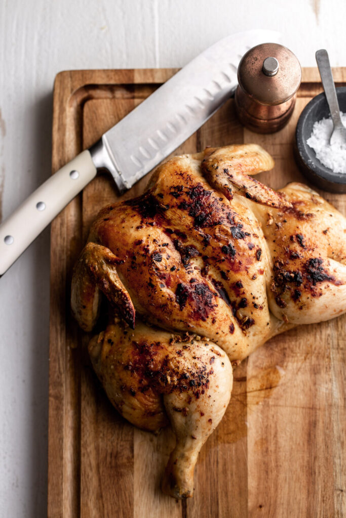 roasted spatchcocked chicken on cutting board 