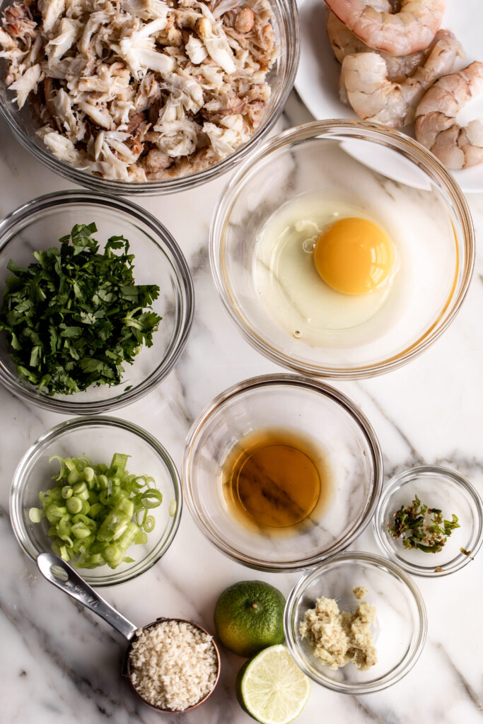 Thai-Inspired Crab Cakes ingredients with crab shrimp egg and herbs