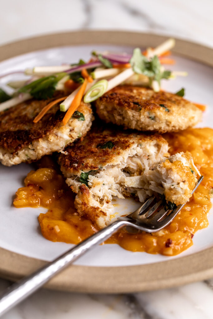 Thai-Inspired Crab Cakes with Mango Chutney & Apple Slaw on plate with fork
