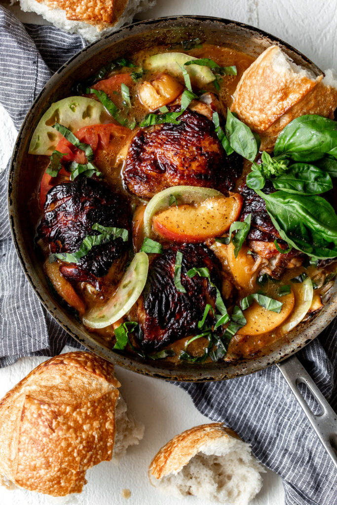 balsamic chicken thighs in pan with peaches and tomatoes 