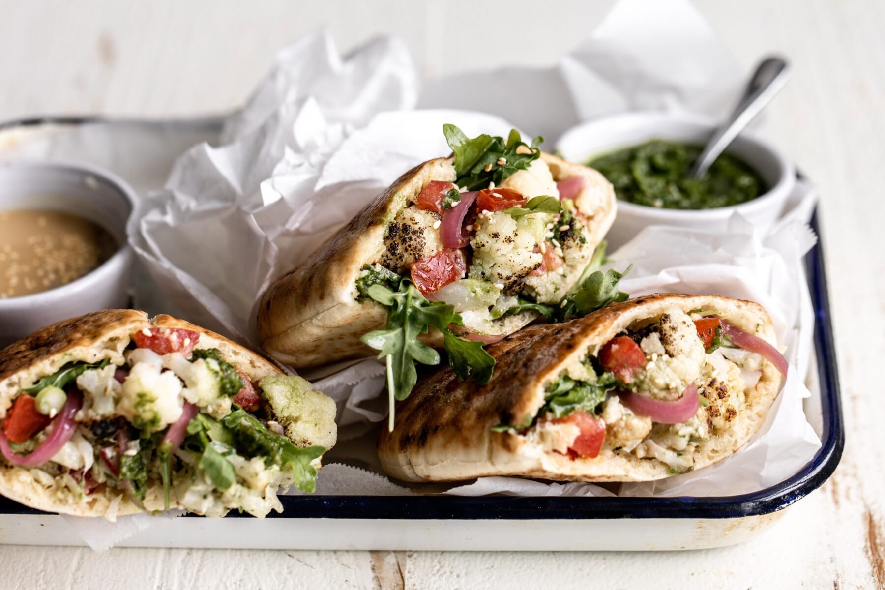 roasted cauliflower pita with arugula and pickled onions.