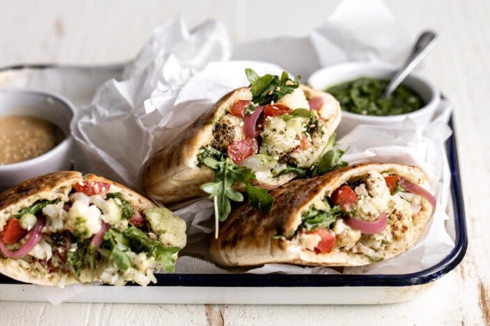 roasted cauliflower pita with arugula and pickled onions.