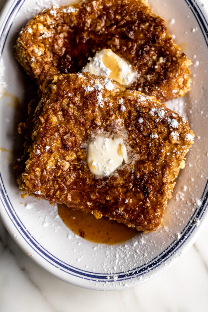 cornflake french toast served with butter maple syrup and confectioners sugar