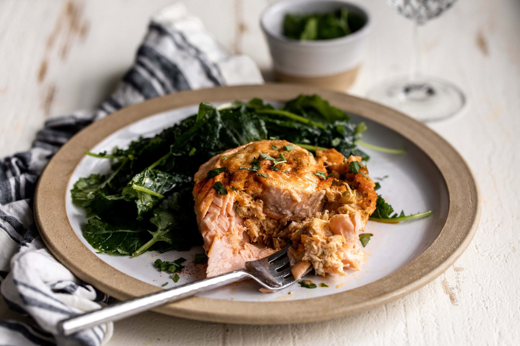 crab stuffed salmon pinwheels with sautéed spinach.