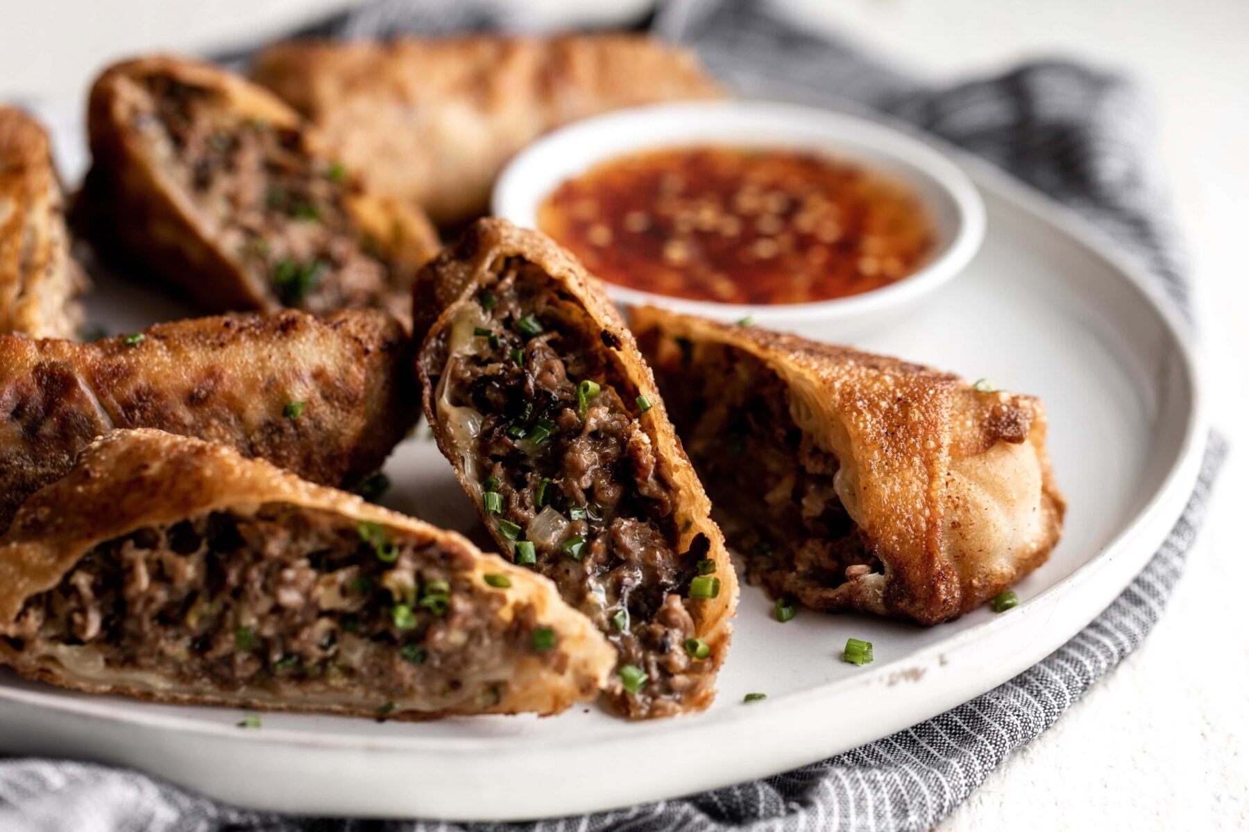 cheesesteak egg rolls with sweet chili dipping sauce.