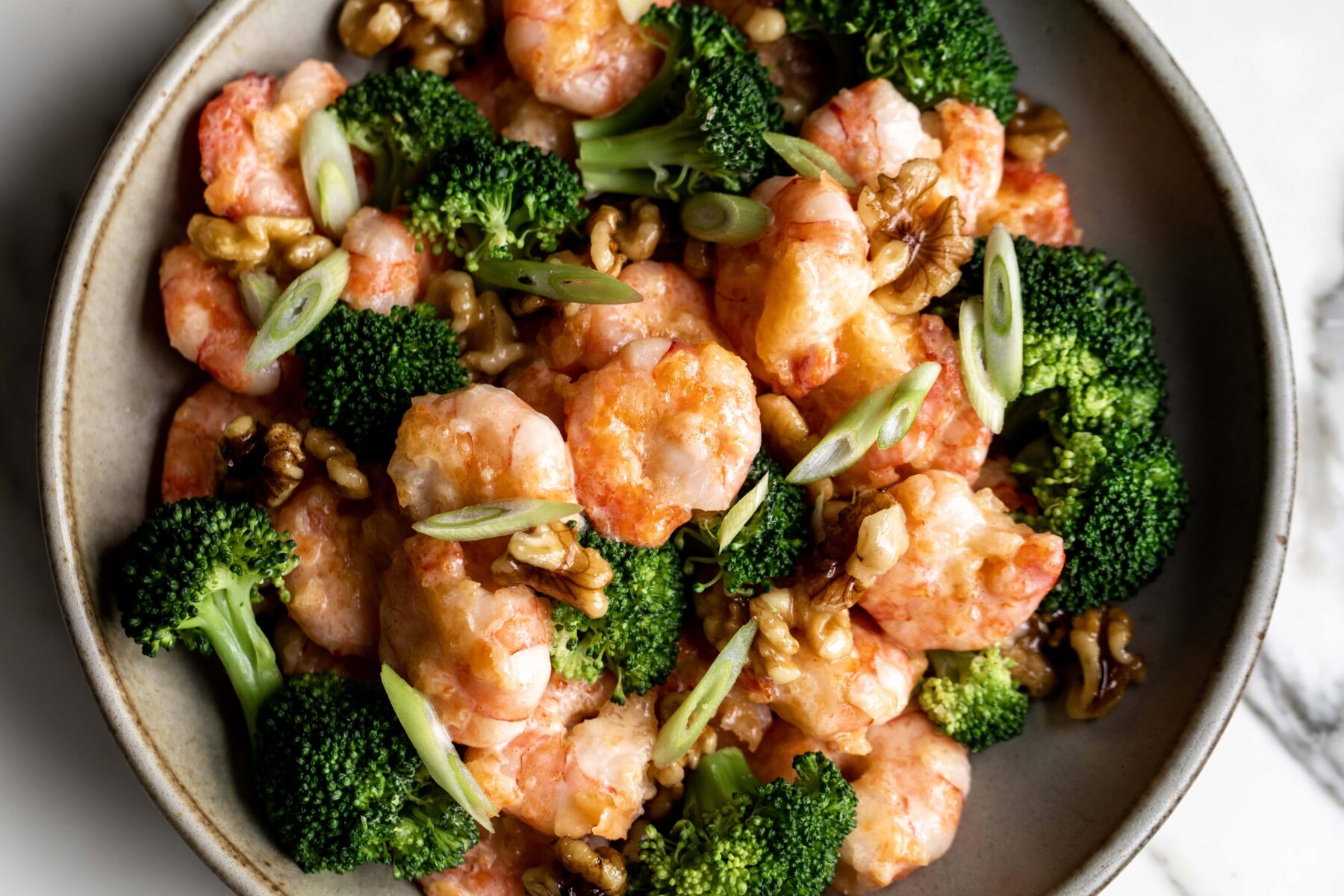 cooked Honey Walnut Shrimp with broccoli florets and candied walnuts.
