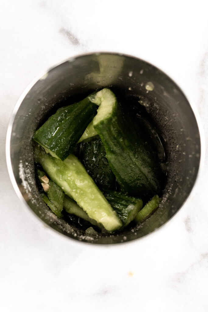 muddled cucumbers and peppers in cocktail shaker