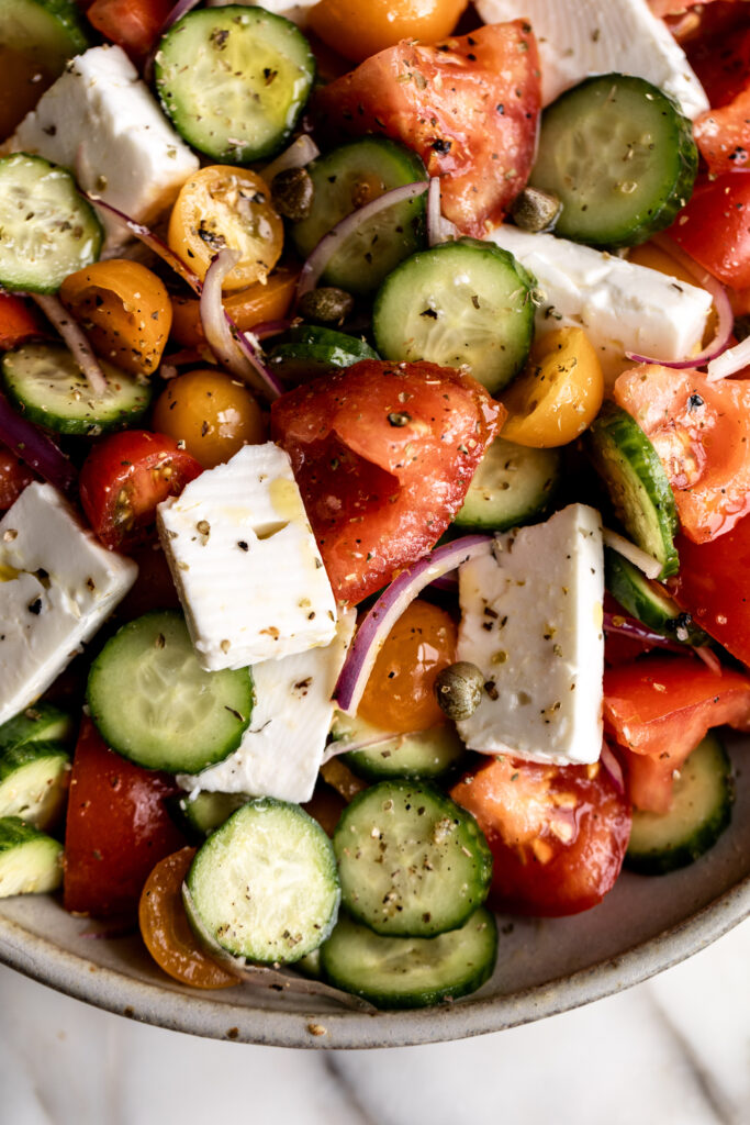 Greek salad with tomatoes, cucumber, red onion and feta closeup