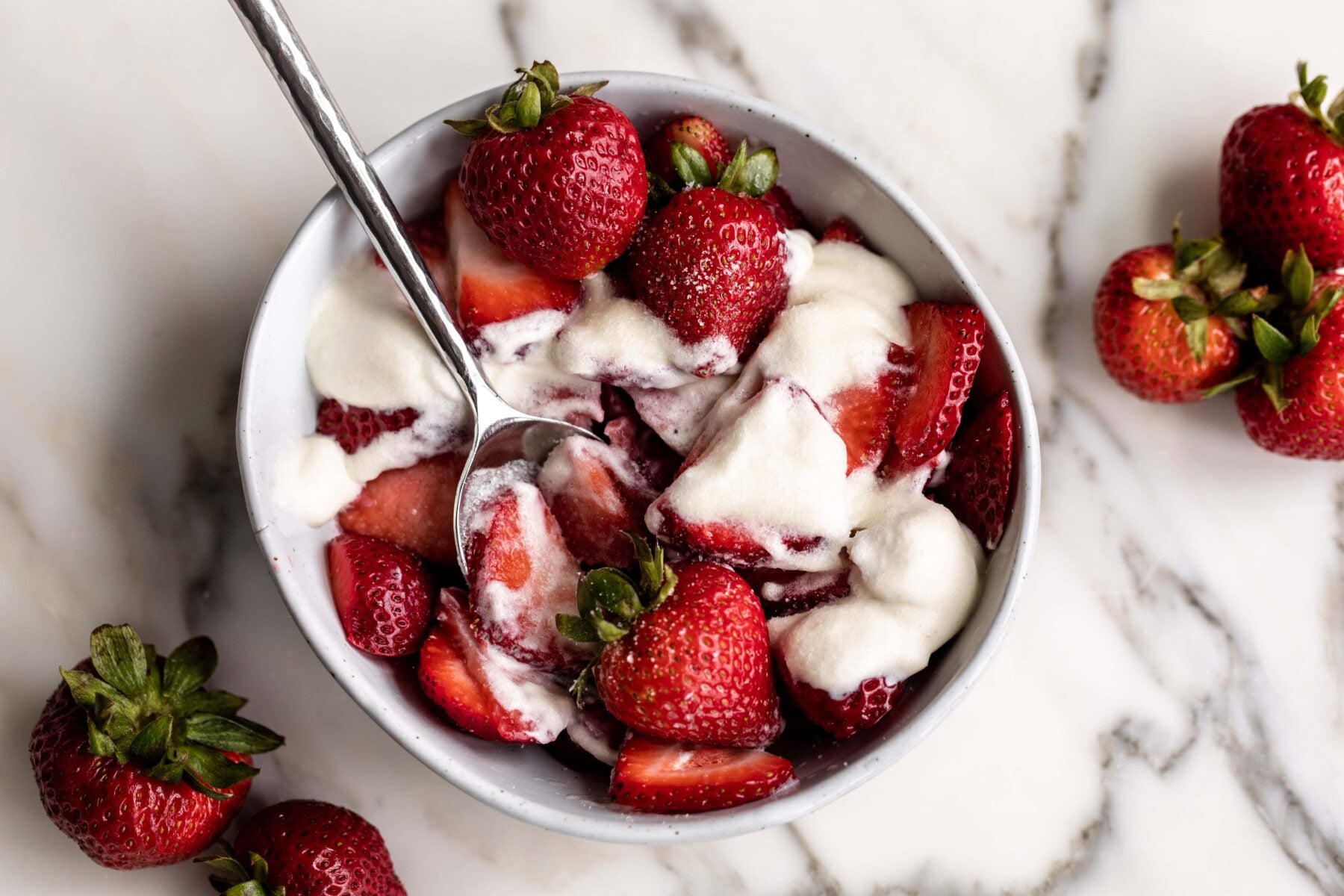 sliced strawberries with lightly whipped cream and sugar.