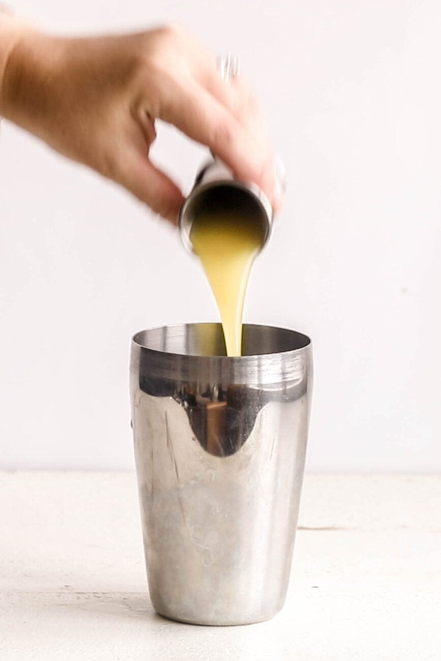 pouring the vodka into the Pineapple Ginger Smash.