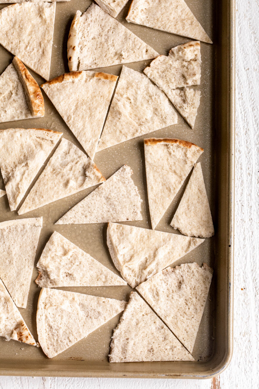 halved pita chips on baking sheet sprayed with vegetable oil.