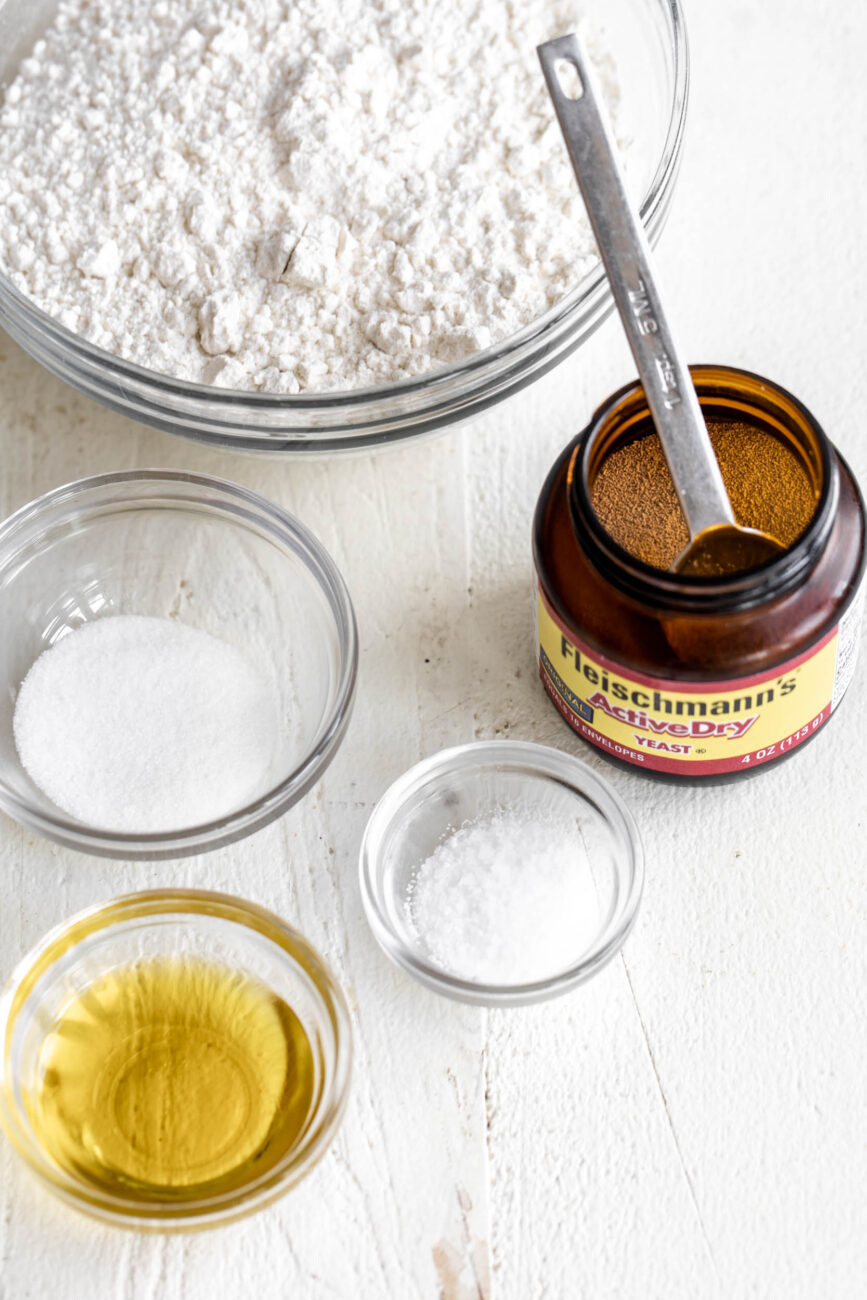 quick and easy homemade pizza dough ingredients in small bowls.