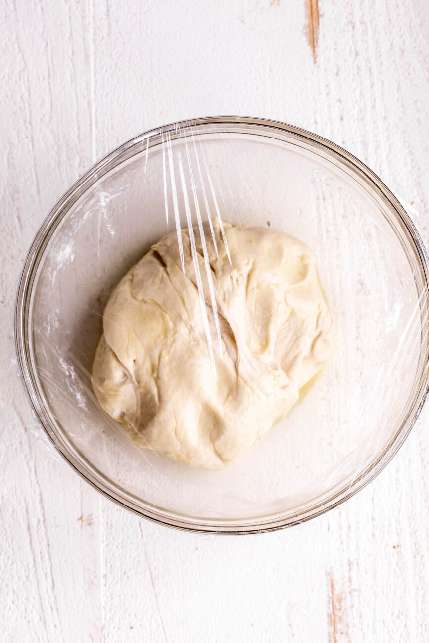 covered pizza dough left to rise.