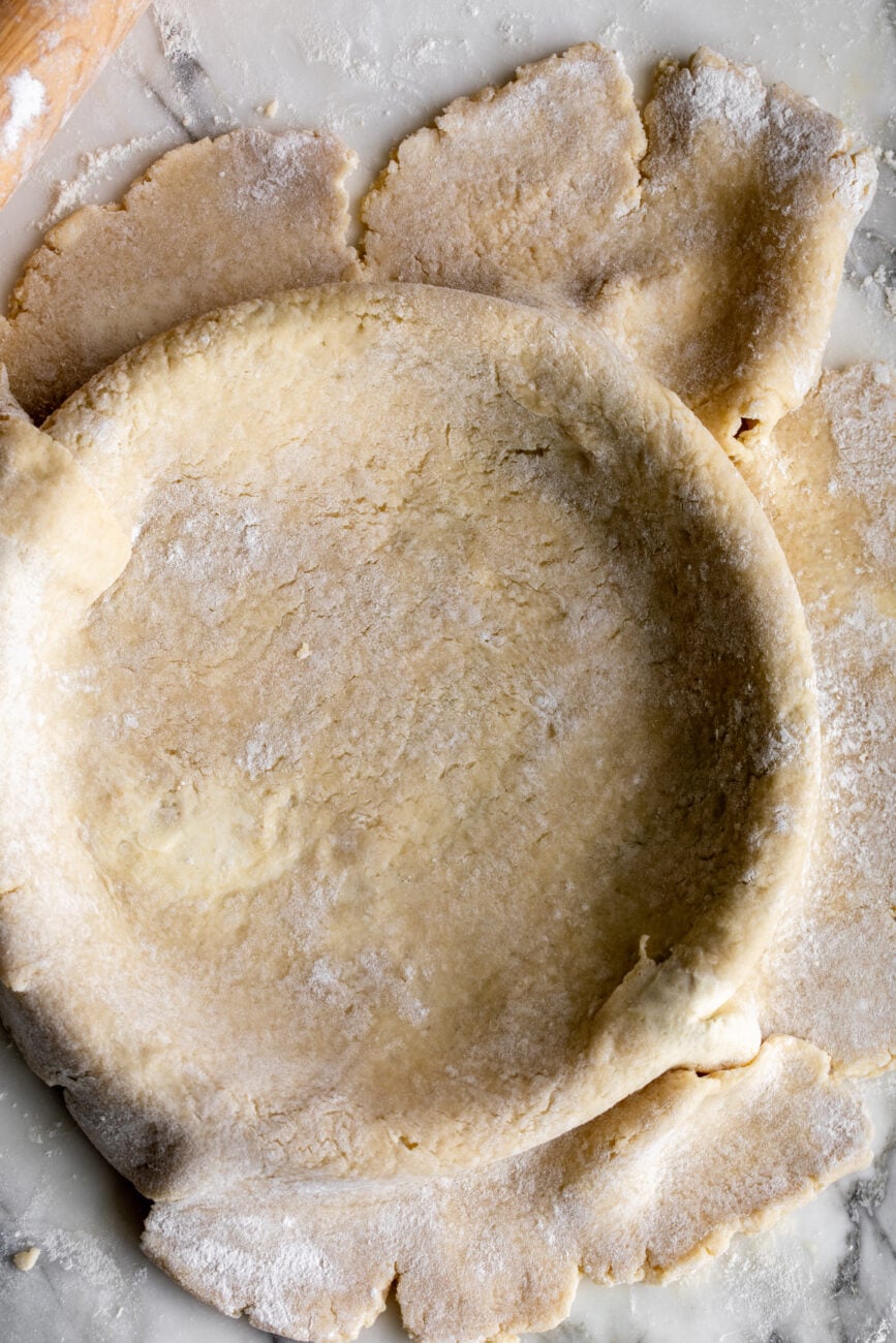 rolled out pie crust on pie plate.