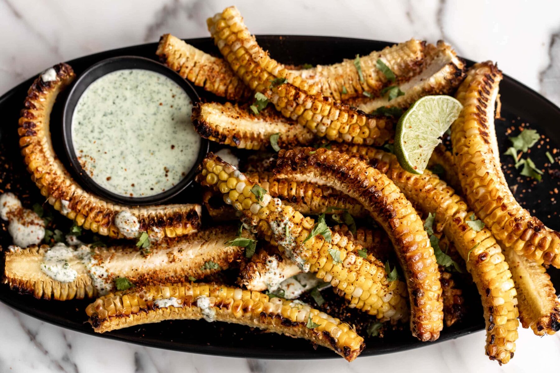 corn ribs with tajin and cilantro lime sauce.