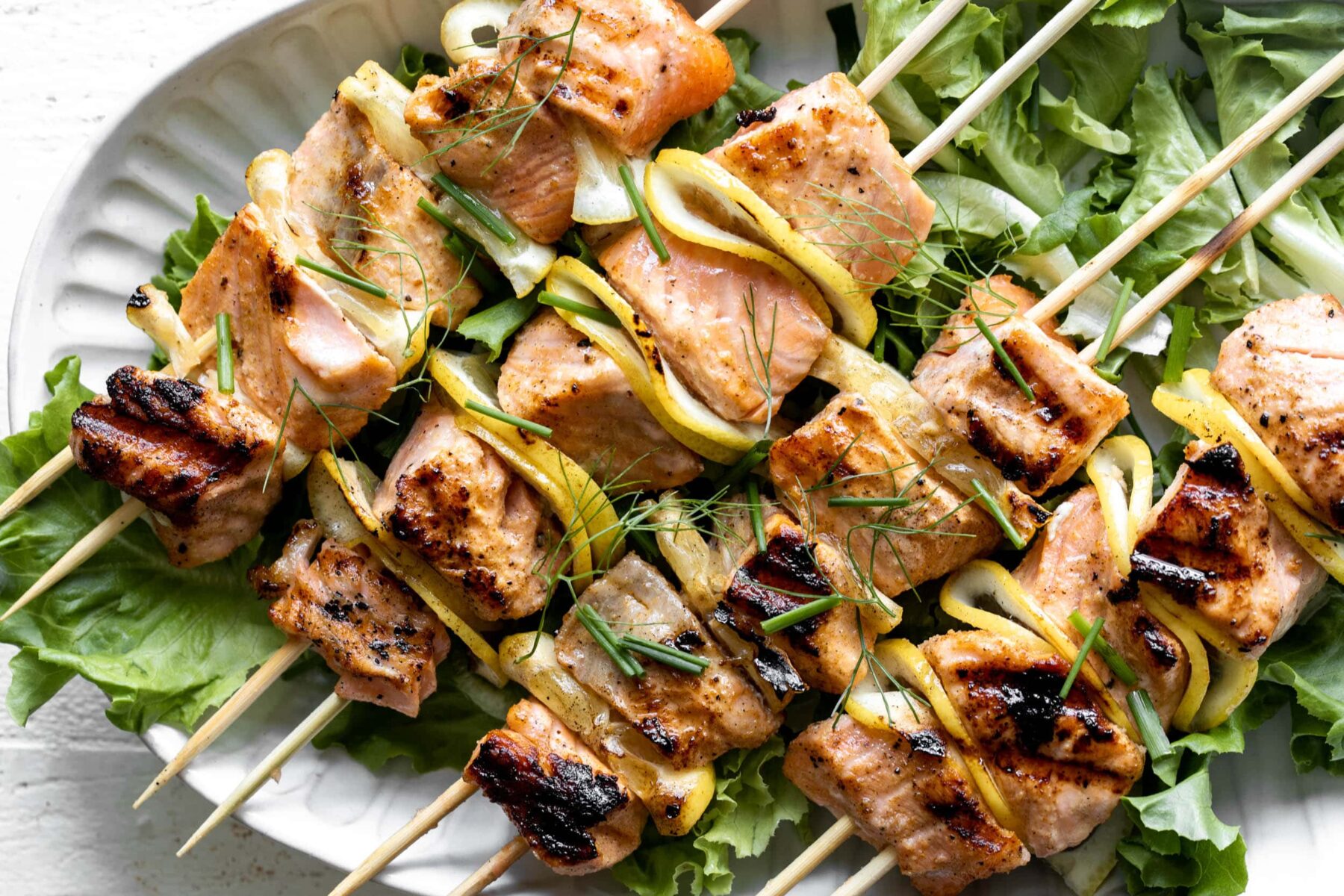 grilled salmon skewers with lemon slices.