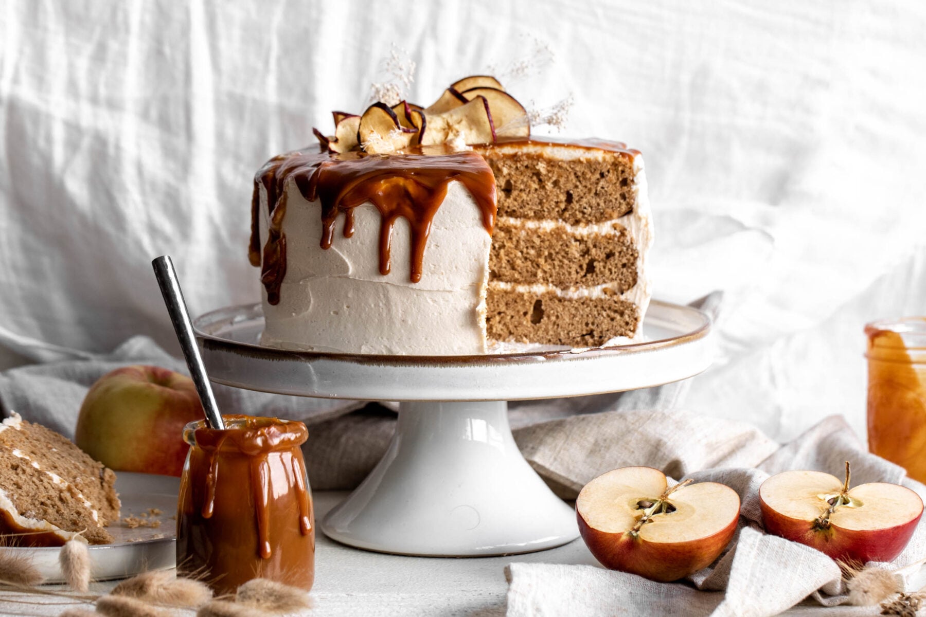 Apple Cake with Caramel Buttercream Frosting cut with caramel.