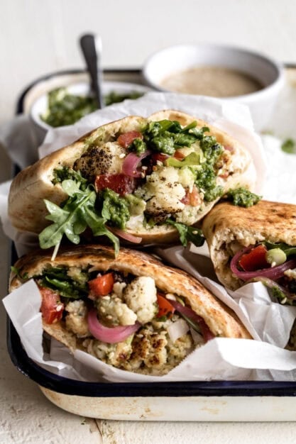 cauliflower pita with tahini and zhoug and pickled red onions.