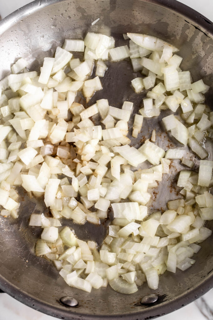 sautéed diced yellow onions in skillet