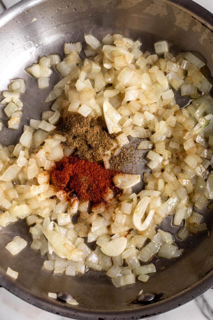 cumin and paprika with sautéed onions and garlic